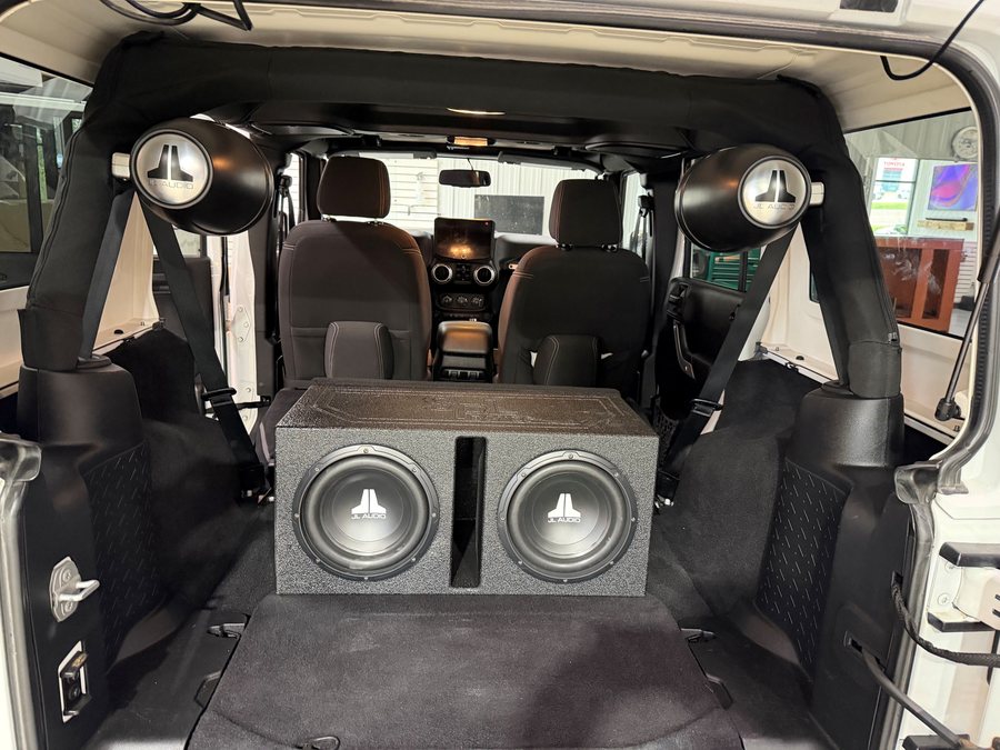 Jeep Wrangler with a custom subwoofer box and tower speakers