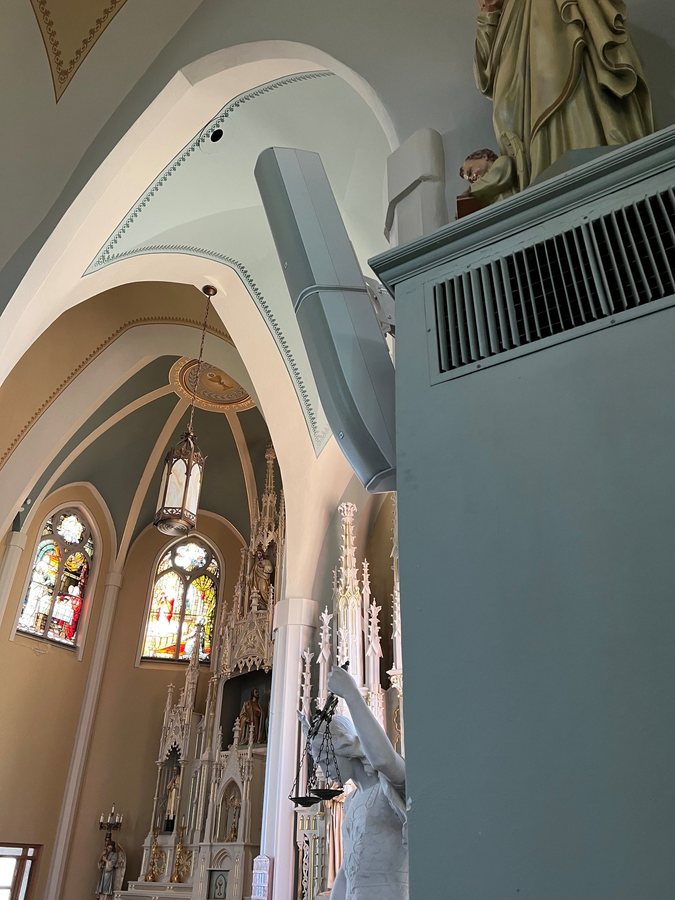 Column mounted speaker inside a historic church