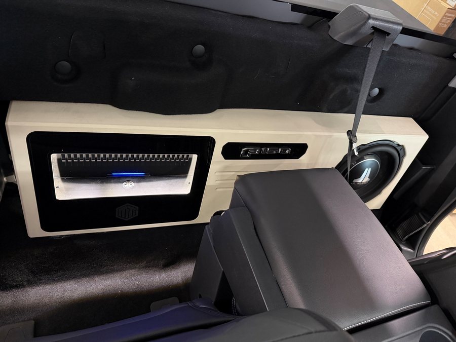 Custom amplifier and subwoofer panel in a truck