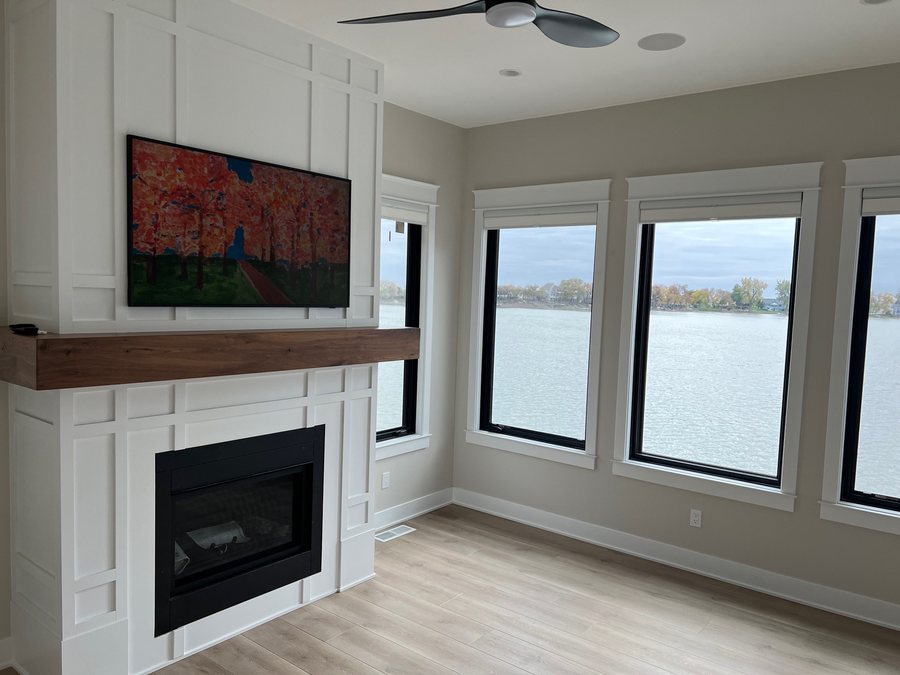 Lake view living room with an art mode TV over the mantel