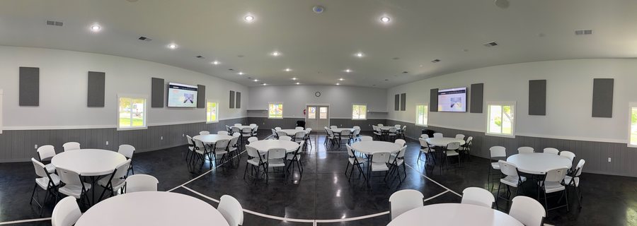 Panoramic view of a banquet hall with displays and acoustic panels