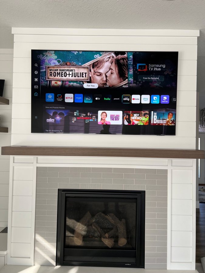 White shiplap fireplace surround with a recessed TV