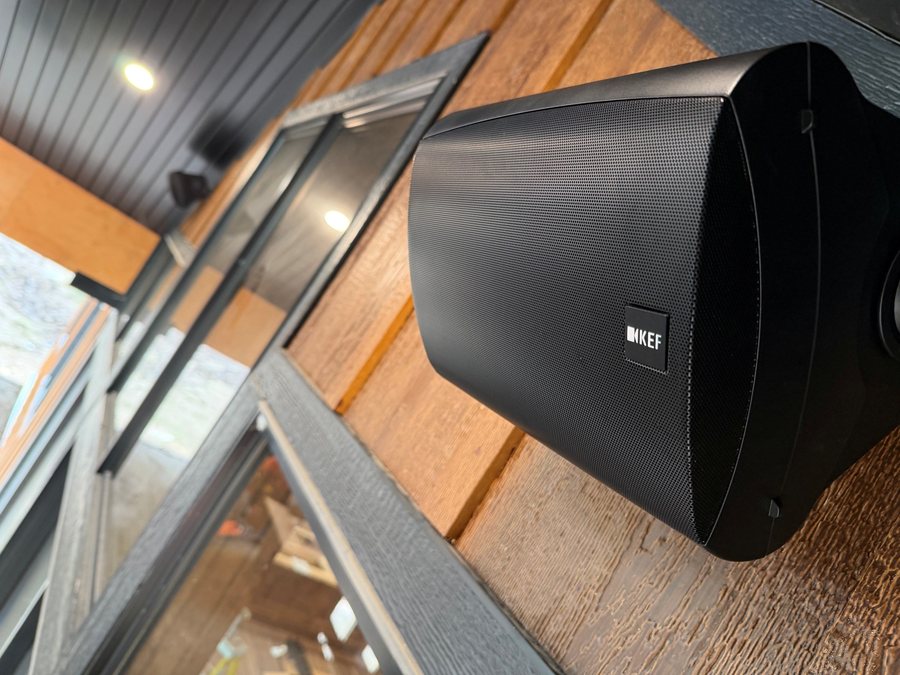 Outdoor speaker mounted under a covered porch