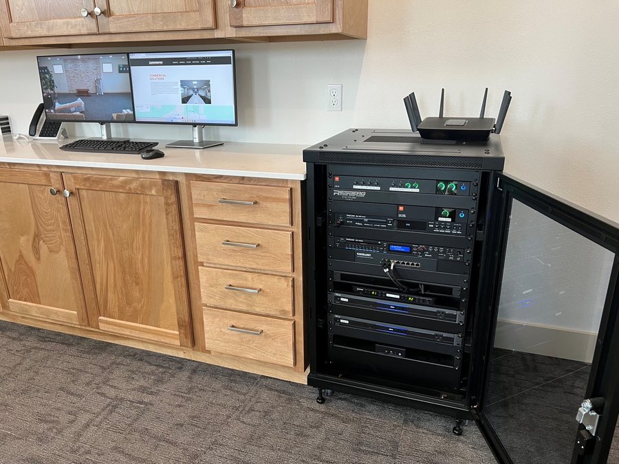Rolling equipment rack beside a control desk