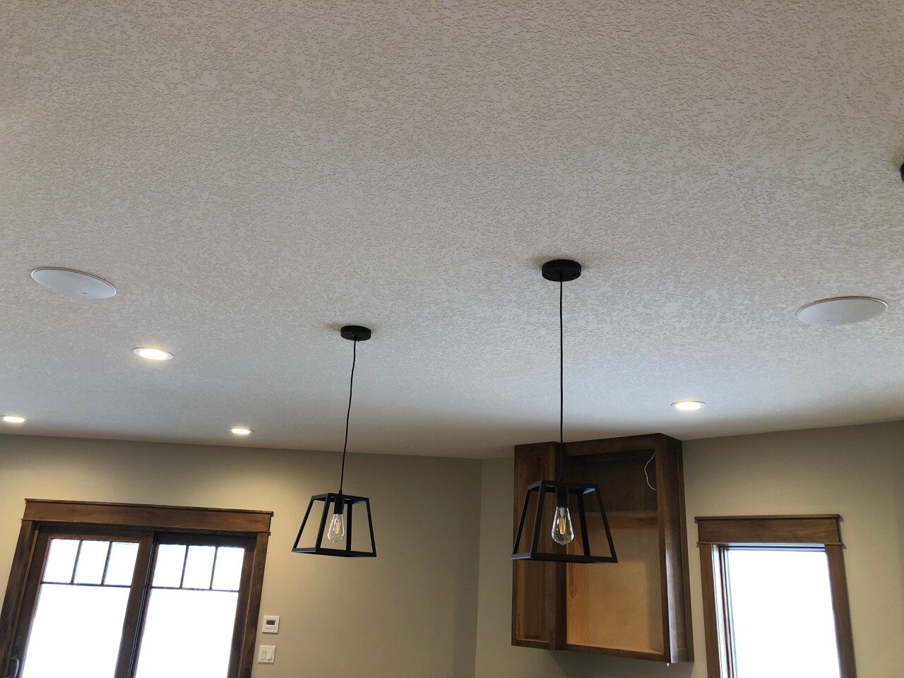 Outdoor television and speakers on a covered patio